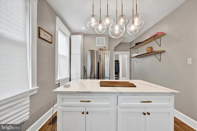 interior space featuring visible vents, wood finished floors, baseboards, vanity, and recessed lighting