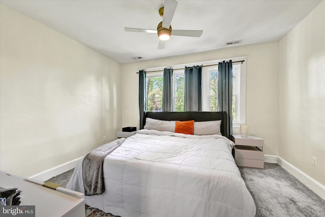 bedroom with visible vents, carpet flooring, baseboards, and ceiling fan
