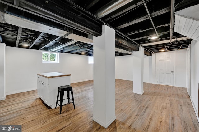 basement featuring light wood-type flooring
