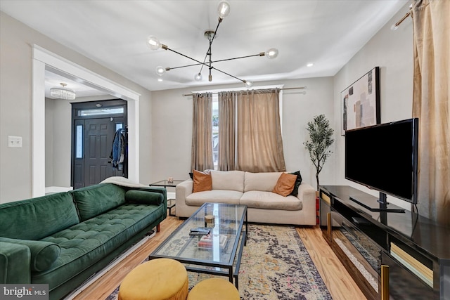 living room with wood finished floors and a notable chandelier