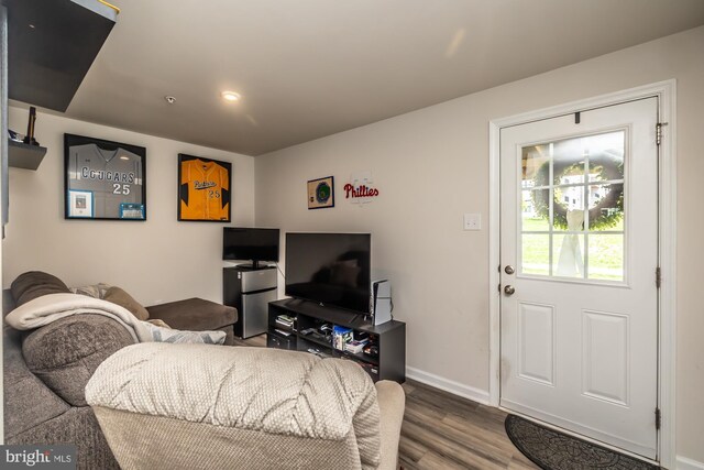 living room featuring baseboards and wood finished floors
