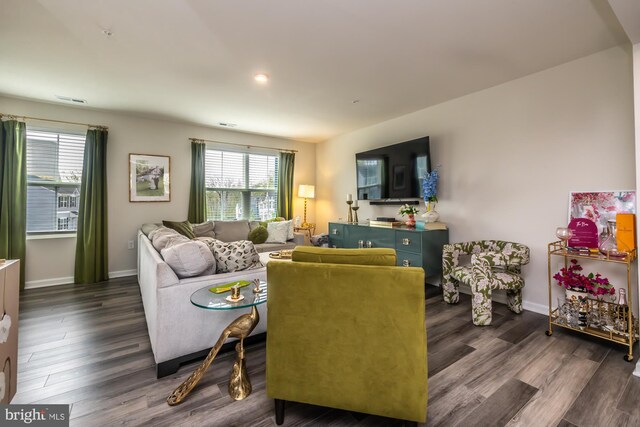 living room with baseboards, dark wood-style flooring, and visible vents