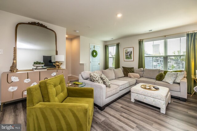 living room featuring recessed lighting, wood finished floors, and visible vents