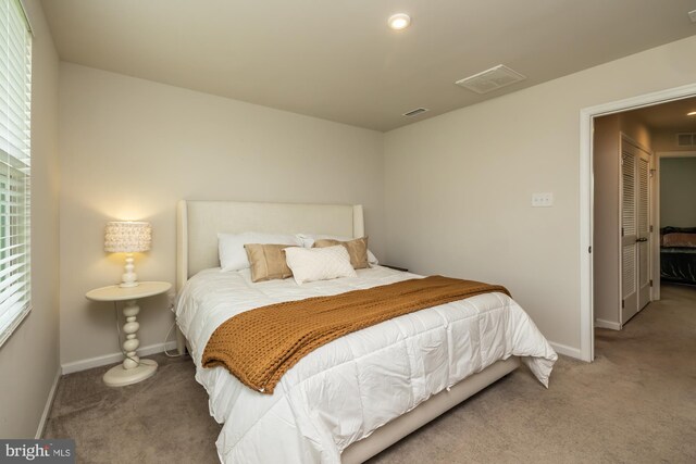 bedroom featuring carpet flooring, baseboards, and visible vents