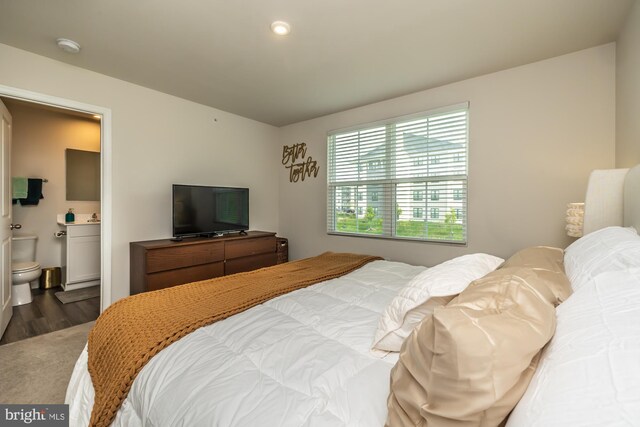 bedroom featuring recessed lighting, wood finished floors, and connected bathroom