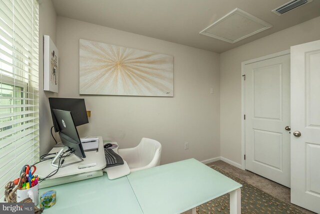 carpeted office featuring baseboards and visible vents