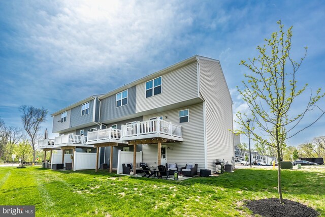 rear view of house featuring a lawn and central AC unit