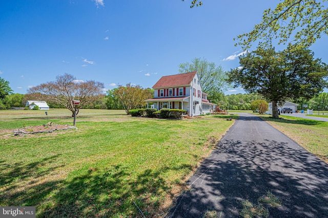 view of front of house featuring a front yard and aphalt driveway