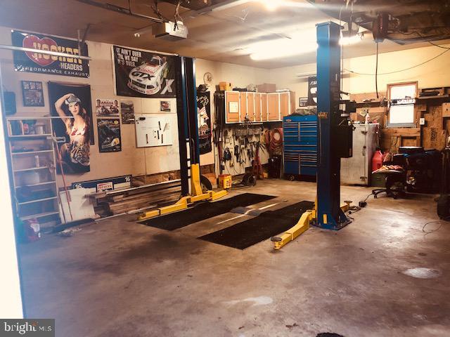 garage featuring a garage door opener and a workshop area