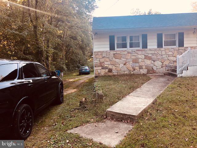 view of side of home with stone siding