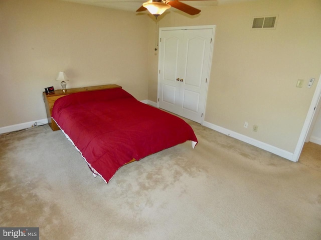 carpeted bedroom featuring a ceiling fan, baseboards, and visible vents