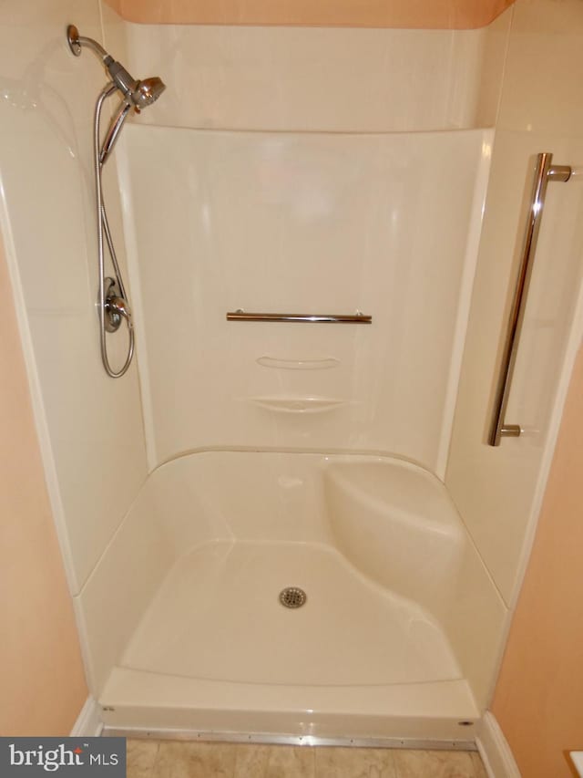 full bath with baseboards and a shower