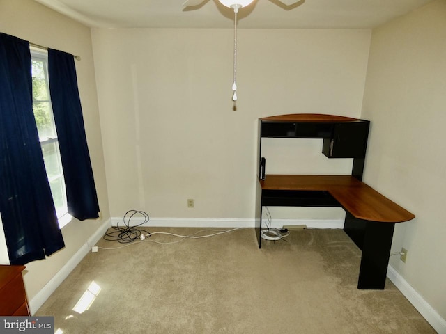 interior space featuring baseboards and ceiling fan