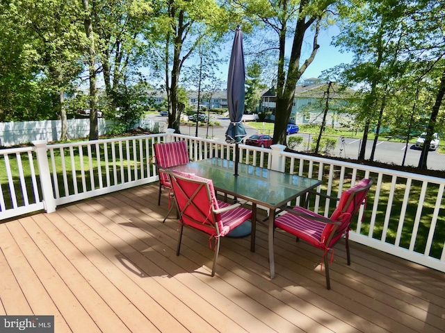wooden terrace with fence and outdoor dining space
