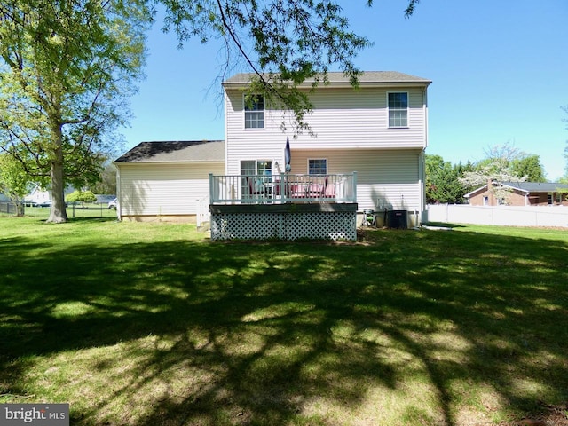back of property with central AC unit, fence, a yard, and a deck