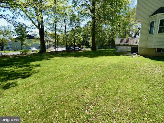 view of yard with a wooden deck and cooling unit