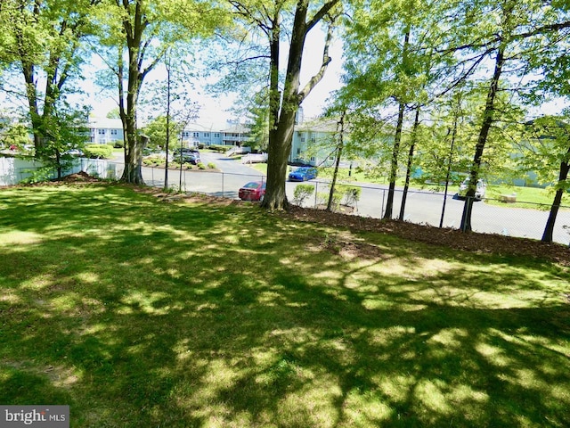 view of yard featuring fence and a residential view