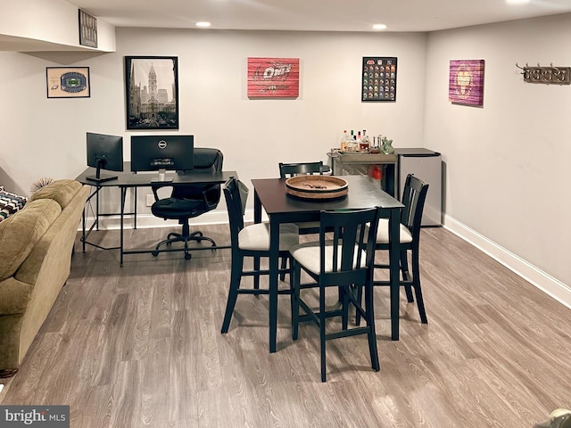 dining space featuring baseboards, recessed lighting, and wood finished floors