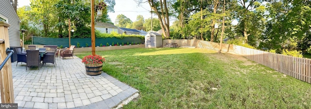 view of yard featuring a fenced backyard, outdoor dining space, and a patio area