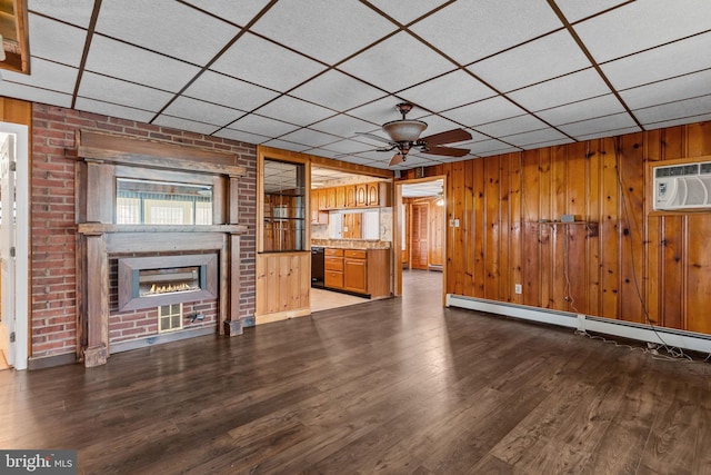 112 Everturn Ln, Levittown, PA 19054 - unfurnished living room featuring a large fireplace, a paneled ceiling, a ceiling fan, wood finished floors, and a baseboard radiator
