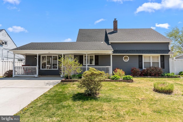 ranch-style home with a shingled roof, a porch, a front yard, a chimney, and driveway