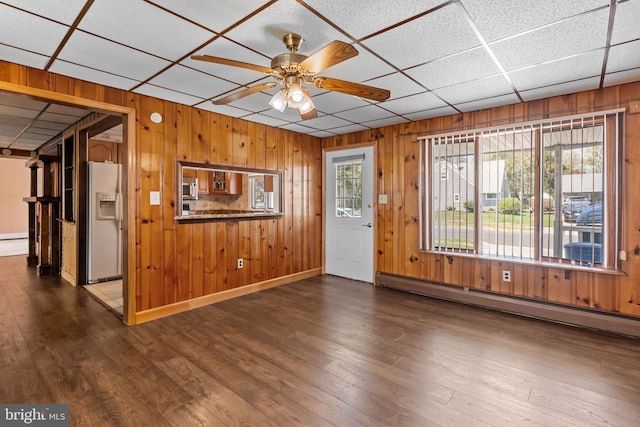 interior space with wooden walls and baseboard heating