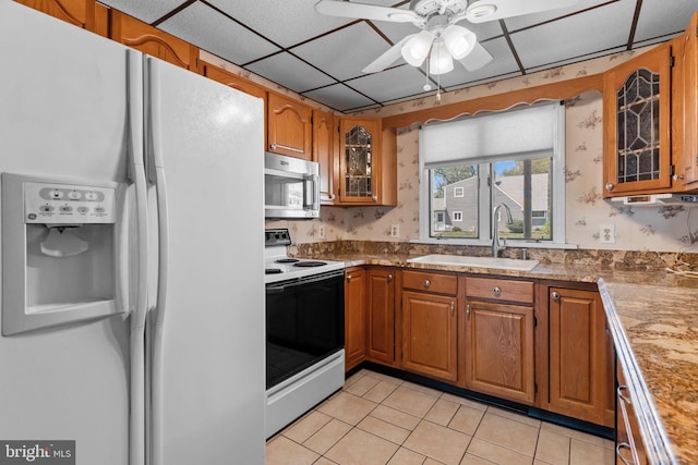 kitchen with ceiling fan, a sink, white refrigerator with ice dispenser, range with electric cooktop, and stainless steel microwave