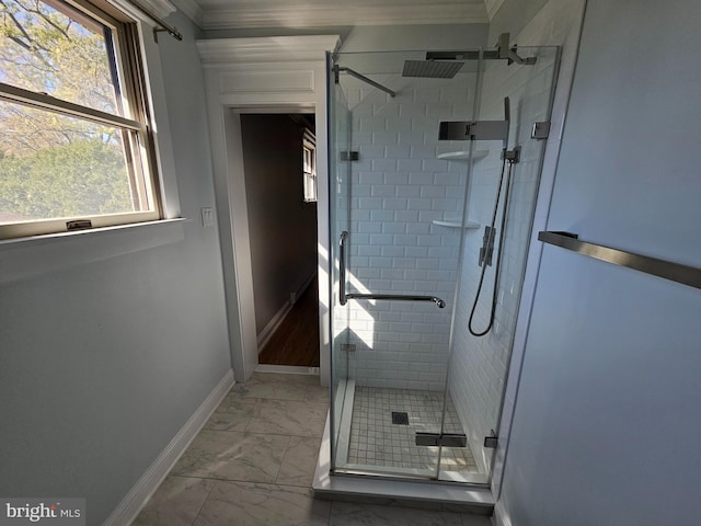 full bathroom with baseboards, ornamental molding, marble finish floor, and a shower stall