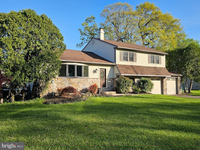 split level home with a chimney, roof with shingles, aphalt driveway, a front lawn, and stone siding