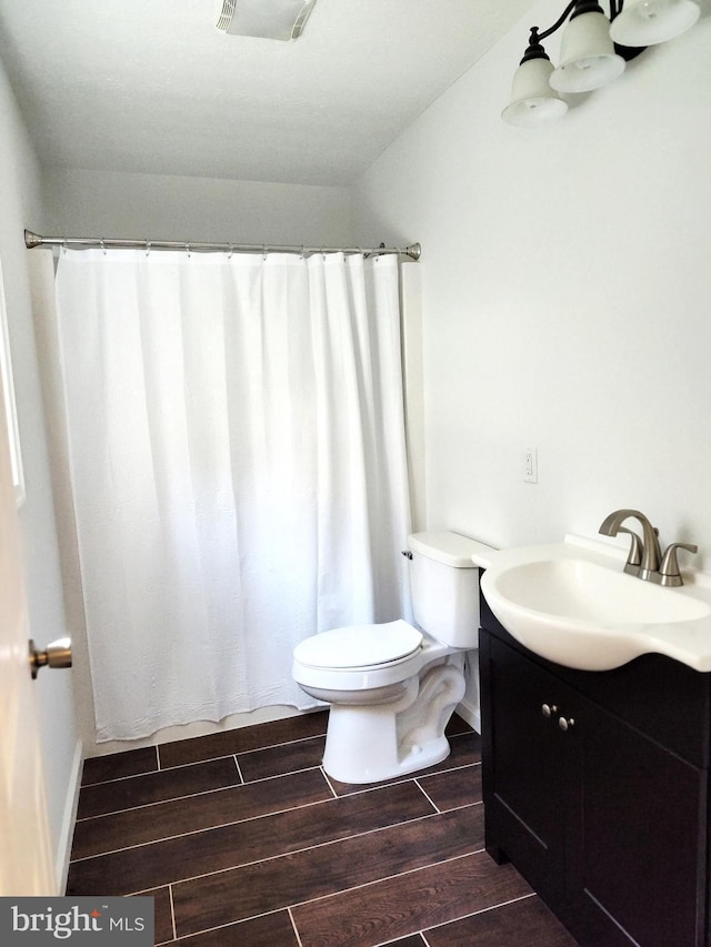 1048 Mill Rd, Woodstock, VA 22664 - bathroom featuring vanity, wood finish floors, toilet, and curtained shower