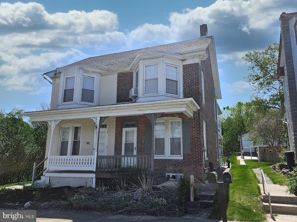 126 Church St, Seven Valleys, PA 17360 - view of front of property featuring a chimney, brick siding, and a porch