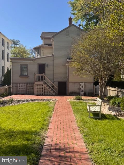 306 Bohemia Ave, Chesapeake City, MD 21915 - back of property featuring fence, a chimney, and a lawn