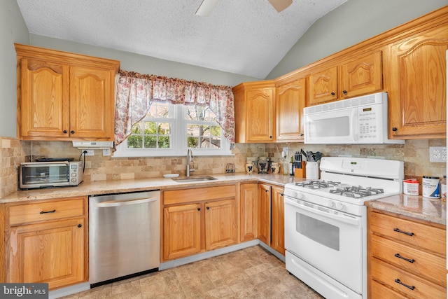 kitchen featuring backsplash, a textured ceiling, a sink, lofted ceiling, and white appliances