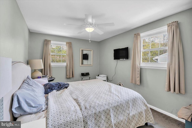 carpeted bedroom with a ceiling fan and baseboards