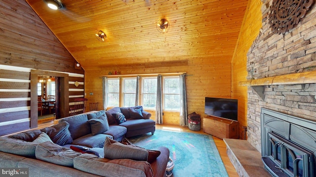 21165 State Road 55, Wardensville, WV 26851 - living area with wood ceiling, high vaulted ceiling, wood walls, wood finished floors, and a stone fireplace