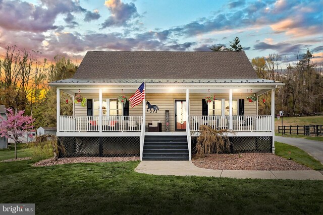 18 Boyds Hollow Rd, Biglerville, PA 17307 - back of house at dusk featuring covered porch, a yard, and stairs