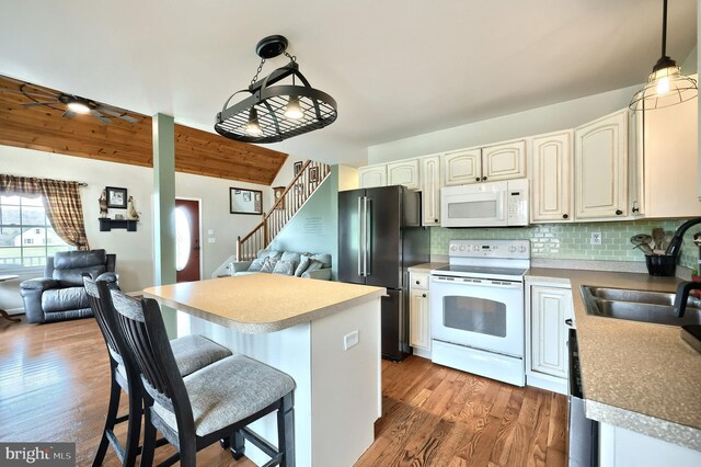 18 Boyds Hollow Rd, Biglerville, PA 17307 - kitchen featuring white appliances, a sink, open floor plan, tasteful backsplash, and decorative light fixtures