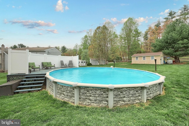 18 Boyds Hollow Rd, Biglerville, PA 17307 - view of swimming pool with a wooden deck, an outdoor structure, and view of wooded area
