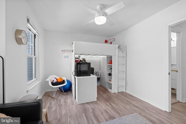 bedroom featuring baseboards, a ceiling fan, and wood finished floors