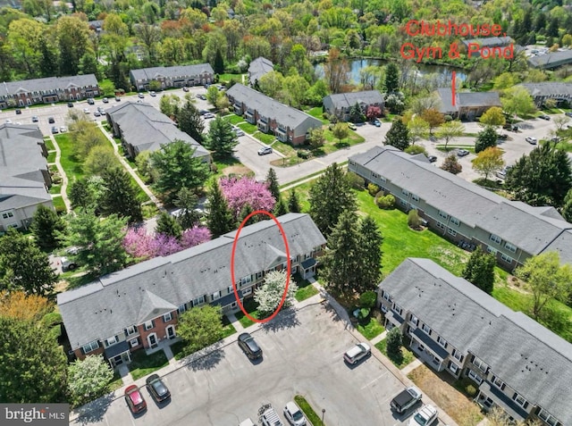 drone / aerial view with a water view and a residential view
