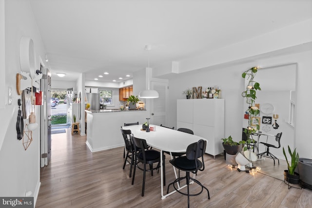 dining area with recessed lighting, baseboards, and light wood-style floors