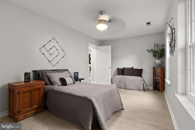 bedroom featuring baseboards, a ceiling fan, and light wood-type flooring