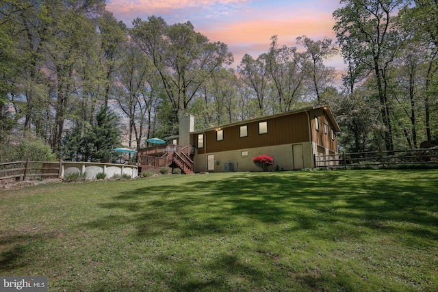 view of yard featuring stairs, fence, and a deck