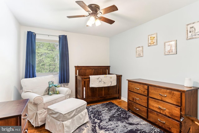 bedroom with ceiling fan and dark wood finished floors