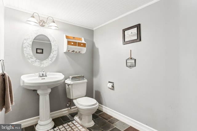 half bathroom with crown molding, toilet, and baseboards