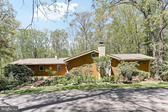mid-century inspired home featuring a chimney