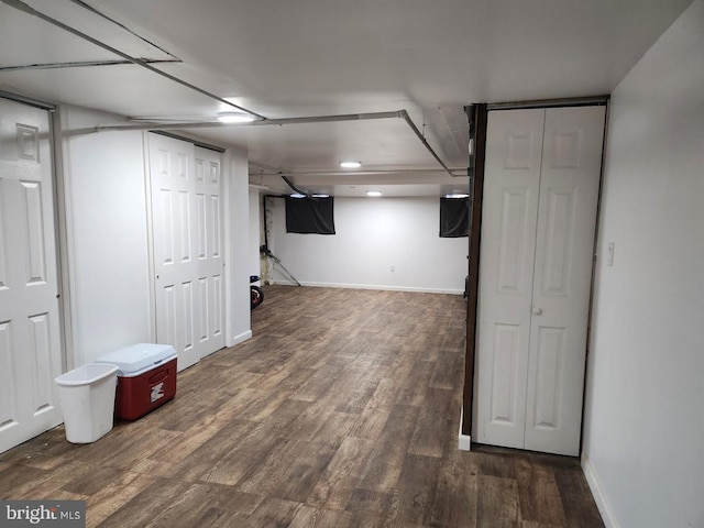 finished below grade area featuring baseboards and wood finished floors