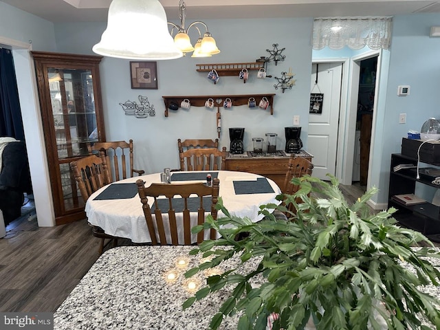 dining area featuring a chandelier and wood finished floors
