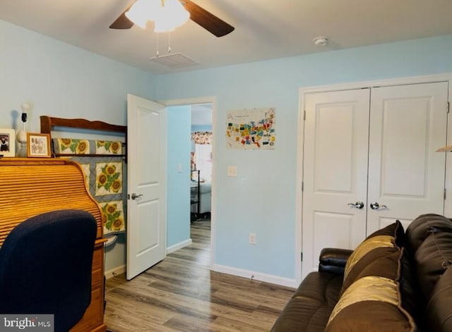 home office with baseboards, ceiling fan, and wood finished floors