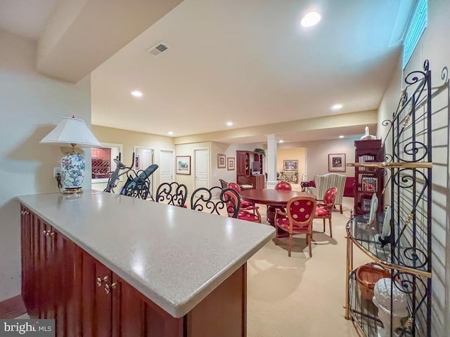11 Mcconkey Dr, Washington Crossing, PA 18977 - kitchen with light colored carpet, a peninsula, visible vents, and recessed lighting